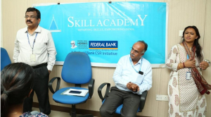 Mr Anil C J, DVP &amp; Head, CSR, Federal Bank, addressing the women students from Idukki district who have joined the orientation programme of Financial Accounting with Tally Prime in the presence of Mr Vinayarajan K V, CEO, S B Global Educational Resources Pvt Ltd and Ms Jayanthi Krishnachandran, Centre Manager, FSA Kochi