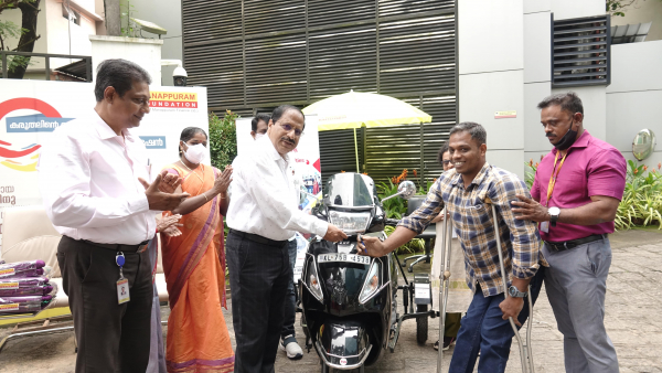 Three-wheeler with Mohammad Shafiq; Manappuram as a handrail