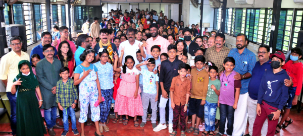 Minister Antony Raju with children at the Kuttikutam event organized by Thiruvananthapuram Press Club. Poet Girish Puliyur, Dr. Indrababu, Press Club President M. Radhakrishnan, Secretary H. and Honey nearby